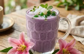 A fresh fruit smoothie made at Pada Thai, served in a mason jar and garnished with a lily